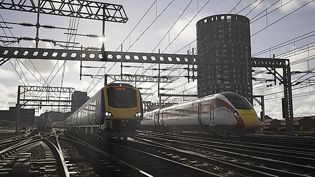 In-game screenshot of two modern passenger trains on parallel tracks beneath overhead wires in front of a tall building.